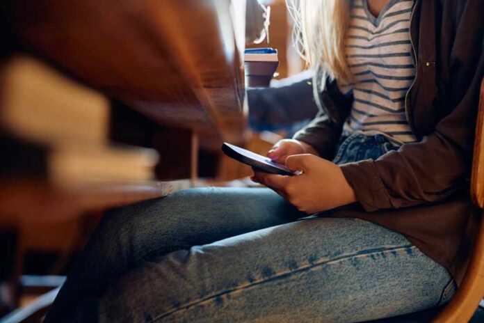 Close,Up,Of,High,School,Student,Texting,On,Mobile,Phone