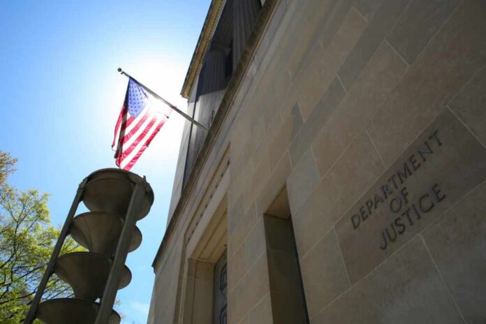 Us,Department,Of,Justice,Building,Under,The,National,Flag,Of