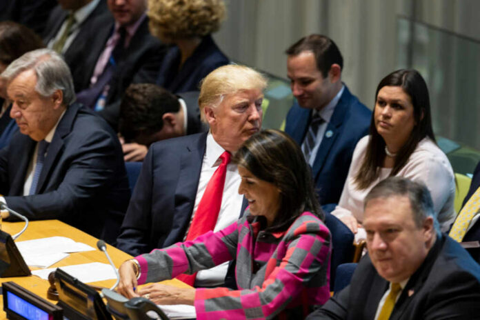 shutterstock_1187477929.jpg A group of political leaders seated at a United Nations meeting, engaged in discussion