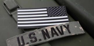 U.S. Navy patch and American flag on a green military surface