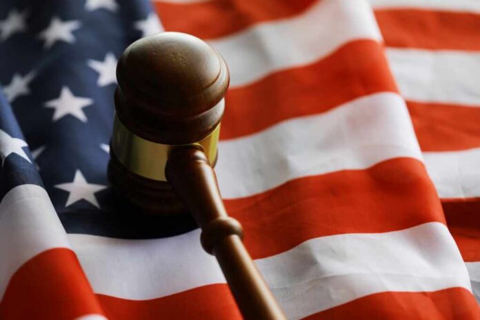 A wooden gavel resting on an American flag