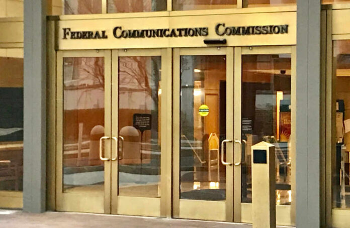 Entrance of the Federal Communications Commission building with glass doors