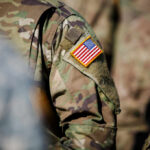 Close-up of a military uniform featuring an American flag patch