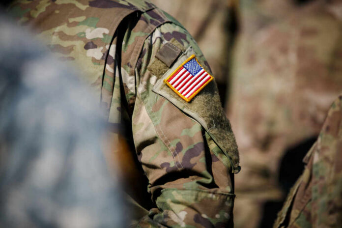 Close-up of a military uniform featuring an American flag patch
