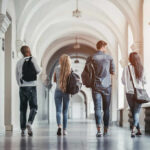 Group of students walking together in a university hallway