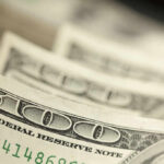 Close-up of several one hundred dollar bills stacked together