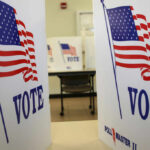 Viral Video Exposes Petition Payment Scheme Voting booths with American flags and the word VOTE displayed