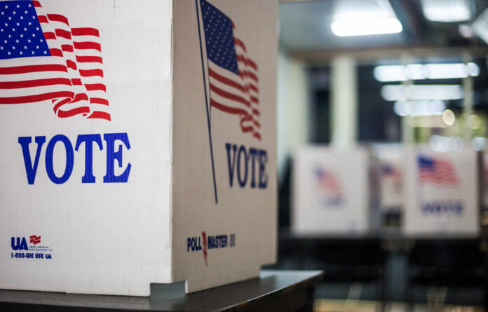 Voting booths with American flags in a polling station
