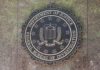Bronze seal of the FBI mounted on a stone wall