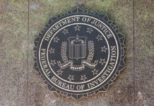 Bronze seal of the FBI mounted on a stone wall