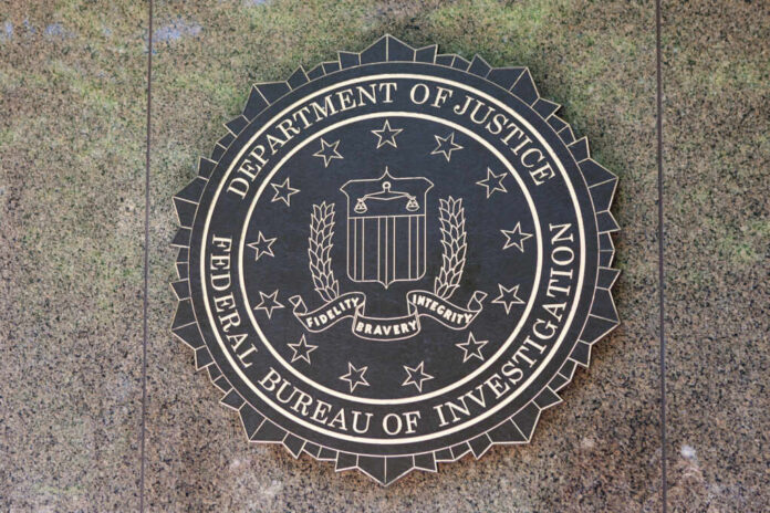 Bronze seal of the FBI mounted on a stone wall
