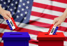 A hand placing a vote into a ballot box with an American flag background