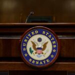 Podium with the United States Senate seal in a formal setting