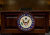Podium with the United States Senate seal in a formal setting