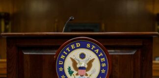 Podium with the United States Senate seal in a formal setting