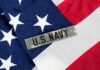 Close-up of an American flag with a U.S. Navy insignia