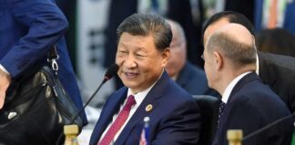 Two political leaders engaged in conversation at a conference table