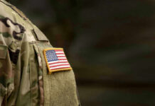 Close-up of a military uniform featuring an American flag patch