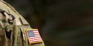 Close-up of a military uniform featuring an American flag patch