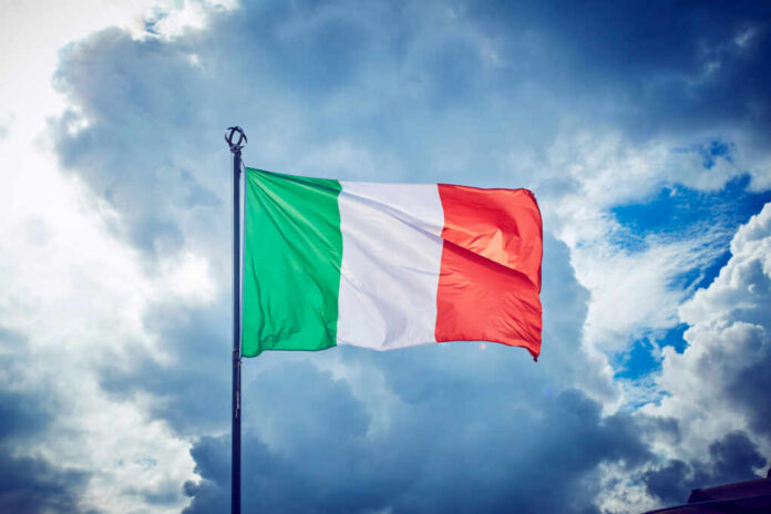 Italian flag waving against a cloudy sky