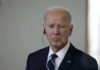 Biden Alleged Delaware Sighting Raises Eyebrows A serious-looking man in a suit with an earpiece, standing indoors