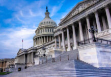 The U.S. Capitol building with its iconic dome and steps under a blue sky