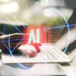 A hand interacting with a laptop displaying an AI symbol