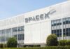 Exterior view of the SpaceX building with a prominent logo