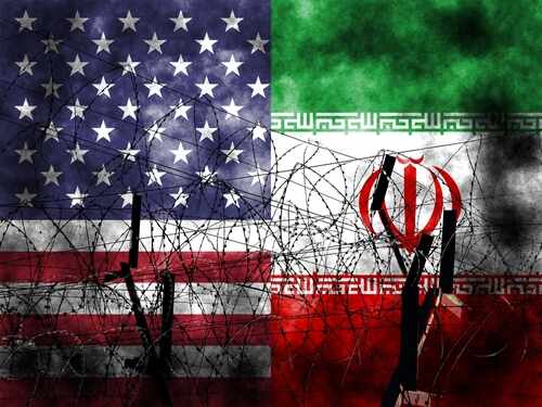 shutterstock_2420760121.jpg American and Iranian flags intertwined with barbed wire