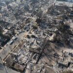 Haifa Horror: Missile Leaves Total Devastation Aerial view of a neighborhood devastated by wildfire, showing burned structures and debris