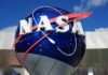 NASA logo displayed on a large blue globe against a clear sky
