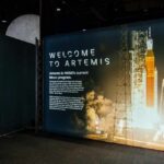 Exhibition display welcoming visitors to the Artemis program with a rocket image