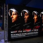Display featuring the Artemis II crew with astronauts in spacesuits