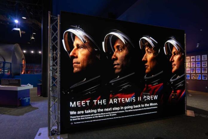 Display featuring the Artemis II crew with astronauts in spacesuits