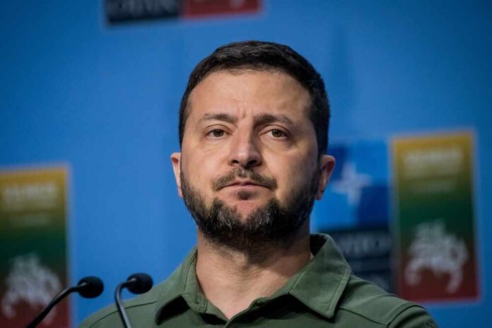 A political leader speaking at a press conference with a serious expression