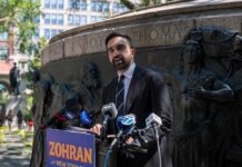 A man delivering a speech at a podium during a public event