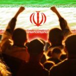 Iran’s SHOCKING Human Shield Tactic Exposed Crowd of people raising their fists in front of the Iranian flag