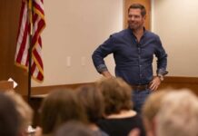 Congress Chaos: Scandal Forces Two Resignations in Hours A speaker engaging with an audience in a professional setting