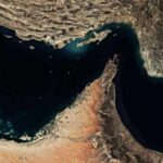 Aerial view of a coastal area with contrasting land and water features