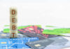 Stack of wooden blocks spelling DEBT on top of various credit cards