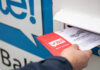 Person placing a mail-in ballot into a voting drop box