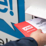 Ballot Fraud Bombshell Rattles Senate Race Person placing a mail-in ballot into a voting drop box