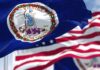 Virginia state flag waving in the foreground with an American flag in the background