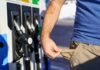 Person at a gas station showing empty pockets
