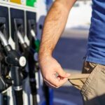 Gasoline Prices Surge to $4.50 National Average Person at a gas station showing empty pockets