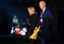 Joe and Jill Biden walking together outdoors at night