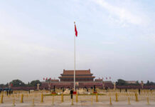 View of Tiananmen Square with the Chinese flag and historical buildings