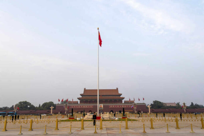 View of Tiananmen Square with the Chinese flag and historical buildings