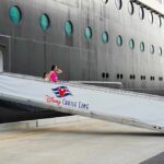 Passengers boarding a Disney cruise ship via a ramp