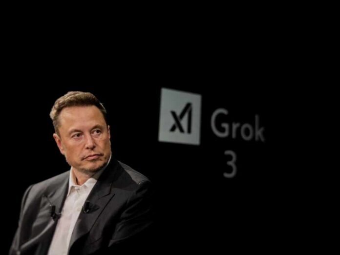 Elon Musk speaking during a technology event with a dark background
